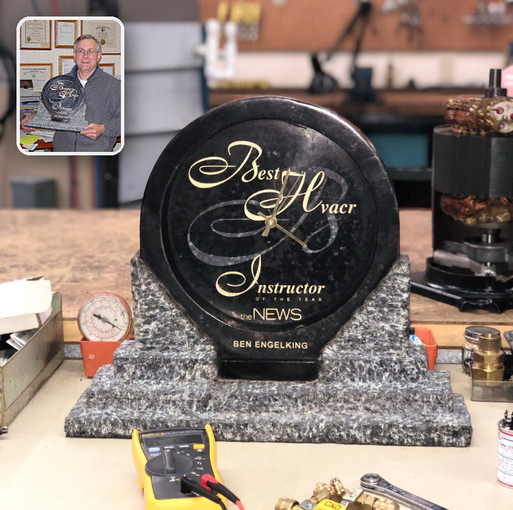 Best HVAC Instructor of the Year award on the workbench with inset portrait of Ben Engelking